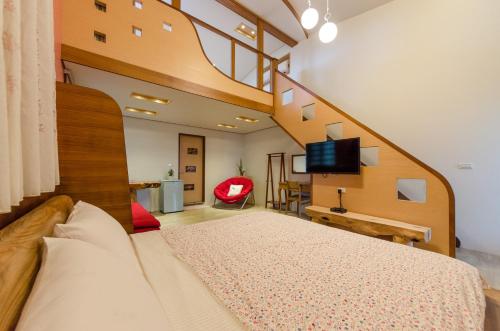 a bedroom with a large bed and a staircase at Xiangyang No 2 B&B in Wujie