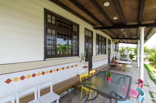 a patio with a table and chairs on a house at Xiangyang No 2 B&B in Wujie
