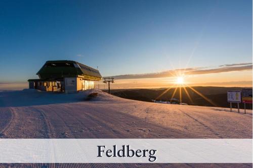 a building on the top of a snow covered hill at Apartment Seelenruhe Falkau 1 in Feldberg