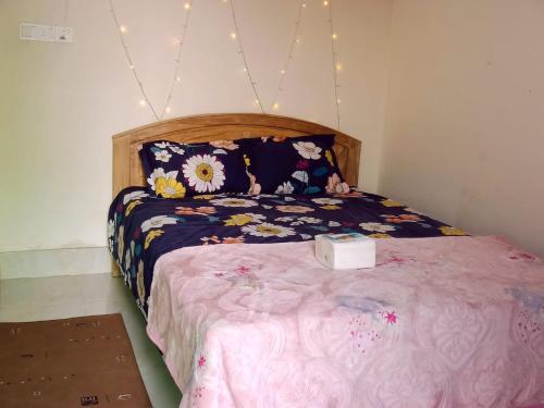 a bedroom with a large bed with flowers on it at Hasnahena 1/F,Dhaka Gurdren City,Adabar,Mohammadpur in Dhaka
