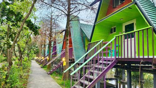 a row of houses painted green and purple at Kitefarm in Dongshan