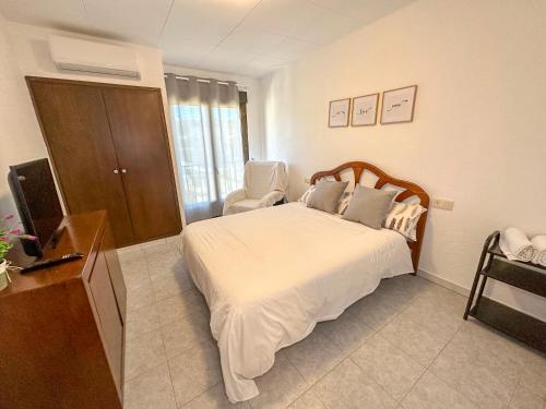 a hotel room with a bed and a television at Camping Gran Sol in Montferrer