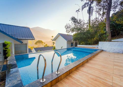 a swimming pool in the backyard of a house at Munnar Majestic Resorts by VOYE HOMES in Anachal