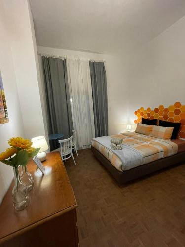 a bedroom with a large bed and a table at Barão 35 Guest House in Braga
