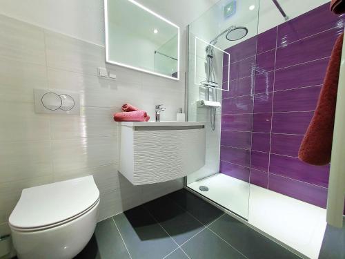 a bathroom with a toilet and a sink and a shower at 1 Haus Linden Osljak in Island Osljak