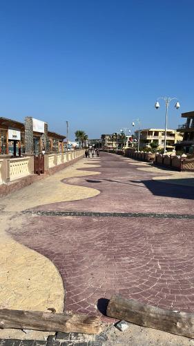 a cobblestone street with people walking on it at Maxeem Direct sea view Apartment super Lux 2 bed rooms Alexandria Maamoura Beach شاليه سوبر لوكس مجموعه مكسيم شاطىء المعموره الاسكندريه على البحرمع كارنيهات بوابه طول السنه و الشاطىء الخاص من اول مايو الى نهايه اكتوبر للعائلات in Alexandria