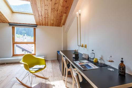 a kitchen with a desk and a yellow chair at Zum Hirschen Boutique Hotel Val di Non in Unsere Liebe Frau im Walde