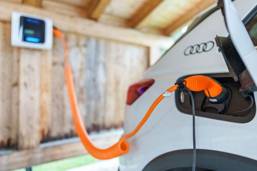 an orange hose attached to the front of a white car at Zum Hirschen Boutique Hotel Val di Non in Unsere Liebe Frau im Walde