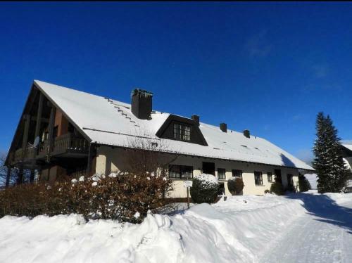 una casa grande con nieve en el techo en Harz-Momente Bruchberg, en Sankt Andreasberg