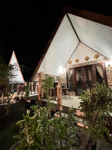 an outside view of a house at night at Meno Melani guesthouse in Gili Meno