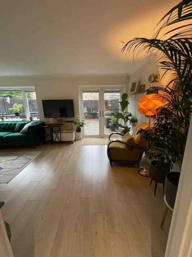 a living room with a couch and a television at Milan Casa in Winnersh