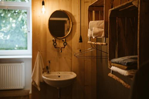 a bathroom with a sink and a mirror and towels at The Keep Eco Rooms in Salzburg
