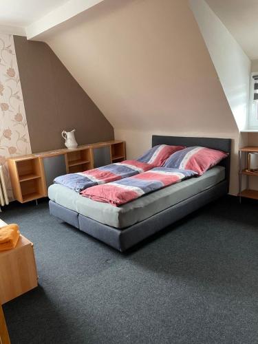 a bedroom with a large bed in a attic at Holiday in Wildflecken