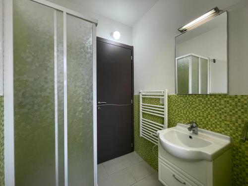 a bathroom with a sink and a shower with a mirror at Mare E Monti Di Simonetta in Spotorno