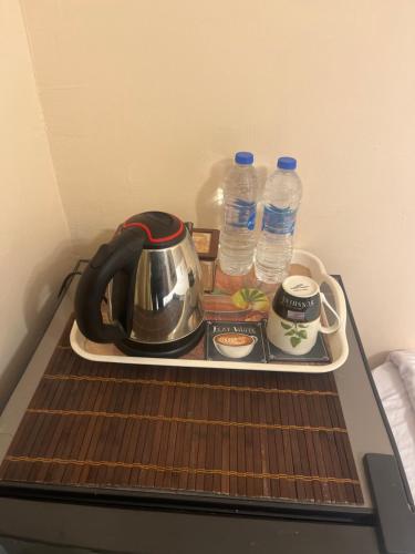 a tea kettle on a tray with bottles of water at Badr pyramids inn in Cairo