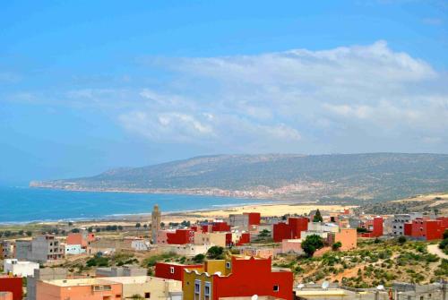 a city with red buildings and the ocean at Dar Océana in Tamraght Oufella