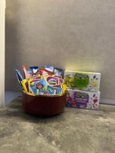 a container of candy on a counter next to a box at Cozy Apartment Anna in Subotica