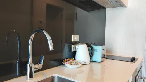 a kitchen counter top with a sink and a sink at Sky Stars Park Apartment in Auckland