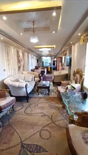 a large living room with couches and a chandelier at الاسكندرية المندرة بحرى in Alexandria