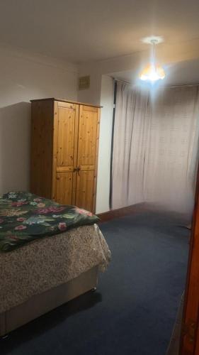 a bedroom with a bed and a dresser and a window at Numan’s guest house in Coundon
