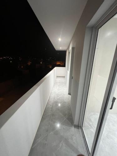 a hallway with a view of a city at night at Brand new apartment in Mindelo in Mindelo