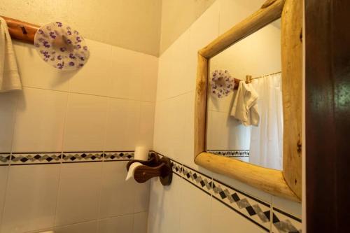 a bathroom with a mirror and a sink at Mise cave lodge in Kapchorwa