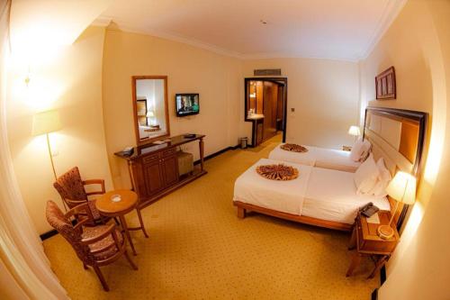 a large hotel room with a bed and a desk at paradise hotel in Cairo