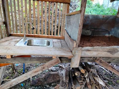 a sink in a wooden garden with a fence at YFS Native Backpackers Inn in Panglao