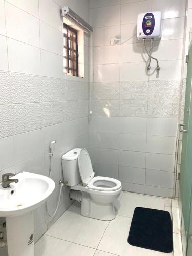 a bathroom with a toilet and a sink at 4 bedroom Luxury Duplex in Lekki