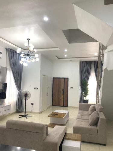 a living room with a couch and a table at 4 bedroom Luxury Duplex in Lekki