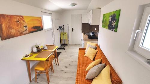 a living room with a couch and a table at Apartmán tiny house v prírode 