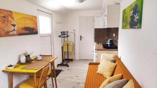 a living room with a couch and a table at Apartmán tiny house v prírode 