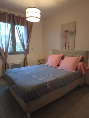 - une chambre avec un grand lit et des oreillers roses dans l'établissement Superbe villa 6 personnes proche océan et lac, à Linxe