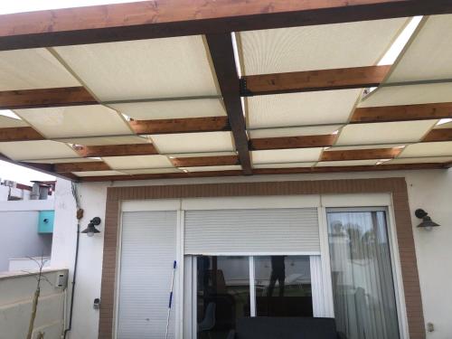 a room with a ceiling with wooden beams at El Globo in Valencia