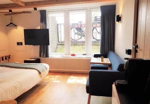 a hotel room with a bed and a window at 23 SouS in Amsterdam