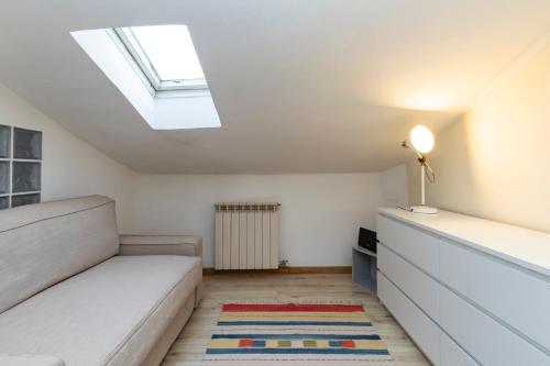 a bedroom with a bed and a skylight at [IHost Apartment] - Adige 17 in Milan