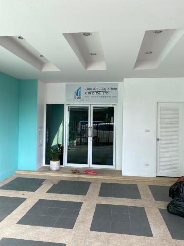 a lobby of a building with a large glass door at Superb Apartment in Ban Na Khua
