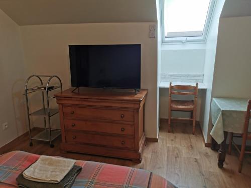 a tv on a wooden dresser in a living room at Chopin 