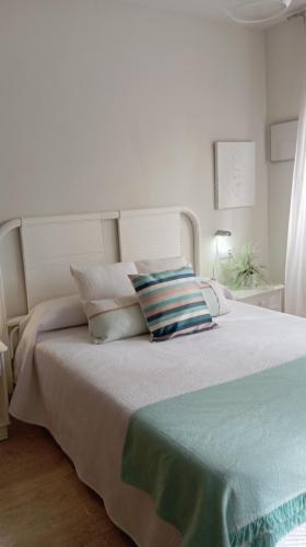a bedroom with a large white bed with pillows at Calafat Ronda del Mar in Calafat