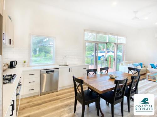 a kitchen and dining room with a table and chairs at The Purple Hen Hideaway Resort in Cowes