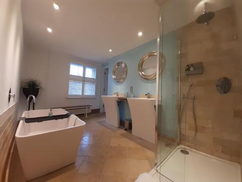 a bathroom with two sinks and a shower at Browns Hotel in Dartmouth