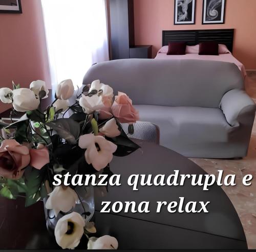 a living room with a couch and a vase of flowers at Lo Studio del Pittore in Vasto