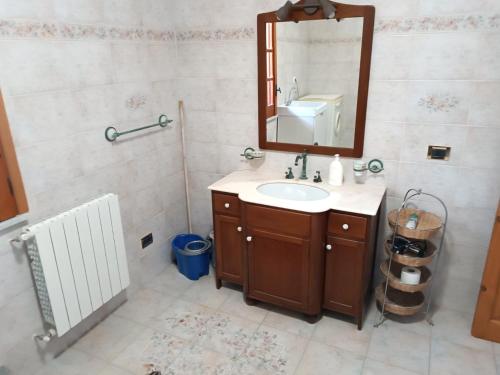 a bathroom with a sink and a mirror at Casa Belvedere in Isnello