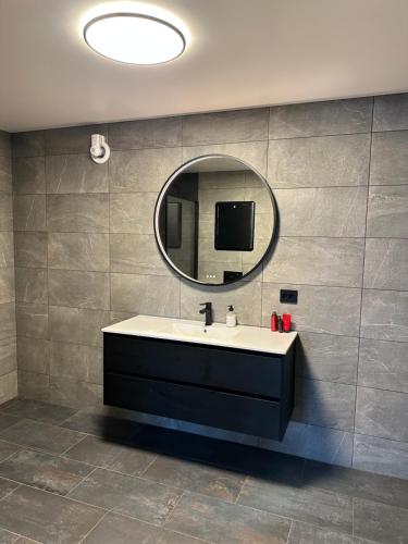 a bathroom with a sink and a mirror at Your home away from home, apartment 1 in Tromsø
