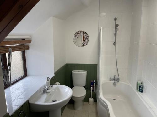 a bathroom with a sink and a toilet and a bath tub at Stunning Cottage with Log Burner in Frosterley