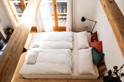 a group of pillows on a couch in front of a window at Waldschlucht in Bad Kohlgrub