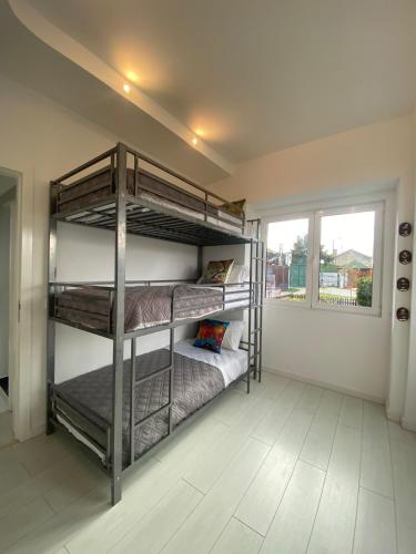 two bunk beds in a room with a window at Belas Rustic Chick in Belas