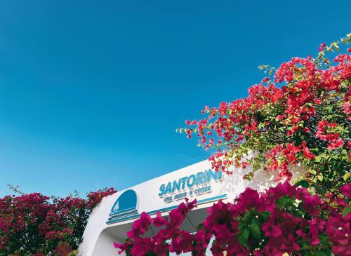 a sign for the sunomon seafood restaurant with pink flowers at Santorini Villa Cam Ranh in Cam Ranh