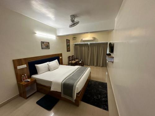 a bedroom with a bed in a room at HOTEL DADO'S INN in Panaji