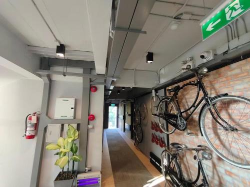 a bike hanging on the wall of a building at Qoo Hotel in Buriram